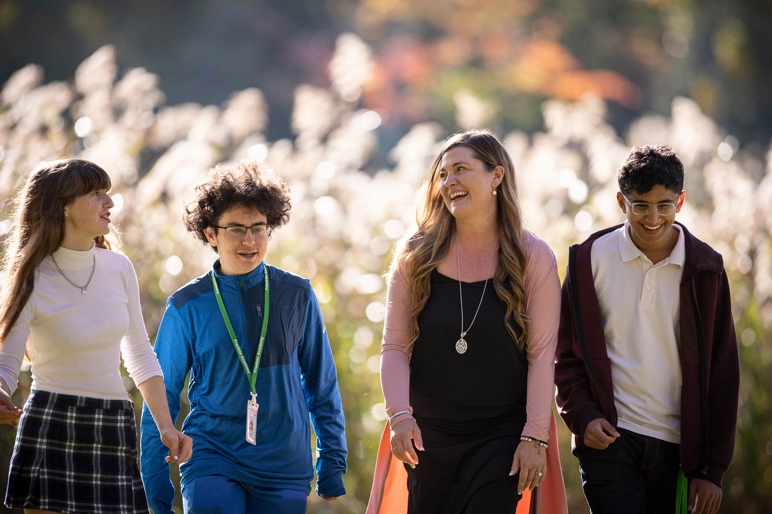 Happy students walking with a teacher